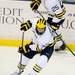 Michigan freshman Alex Guptill moves the puck down the ice as teammate senior David Wohlberg looks on in the first period at Yost Arena on Friday night. Melanie Maxwell I AnnArbor.com